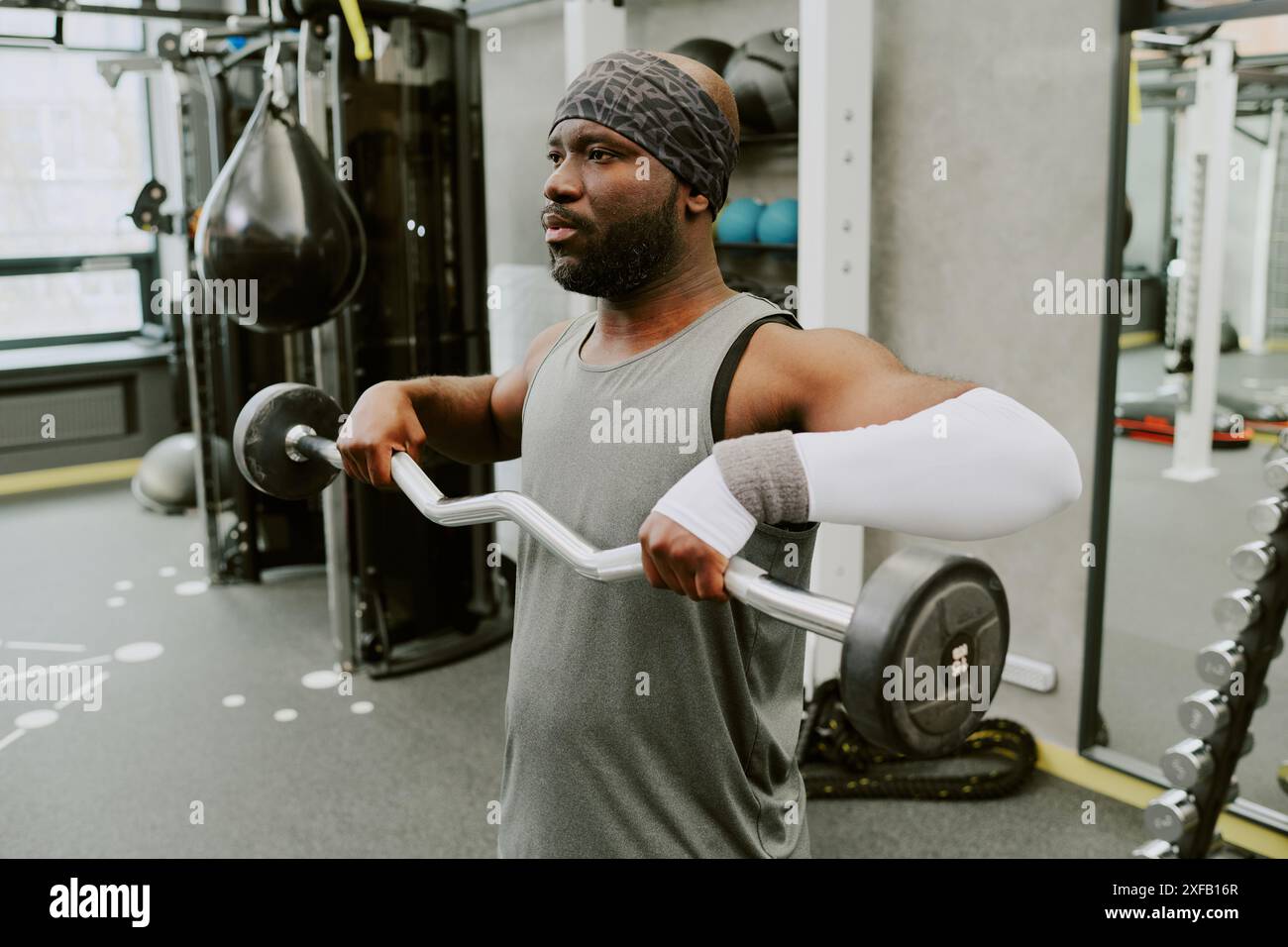 Young African American man doing high pull to make his shoulder muscle stronger Stock Photo