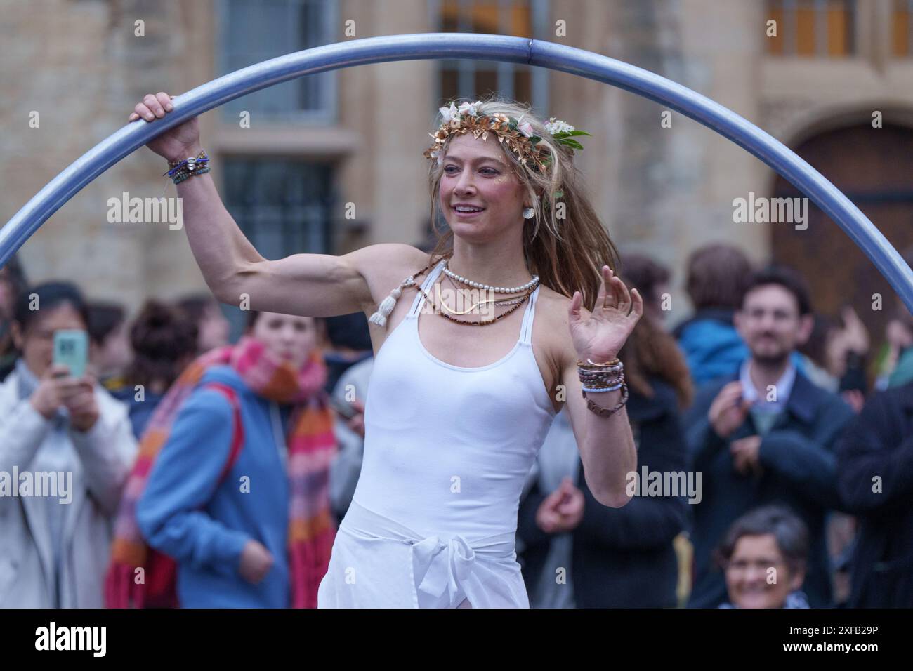 Ariel Dempsey displays her skills dancing using a Cyr Wheel, Mayday, on the streets of Oxford, England Stock Photo