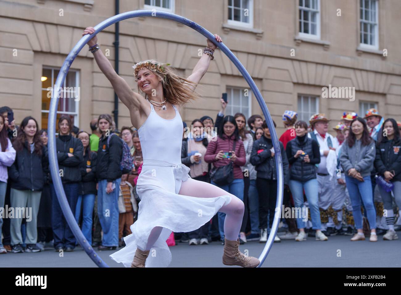 Ariel Dempsey displays her skills dancing using a Cyr Wheel, Mayday, on the streets of Oxford, England Stock Photo