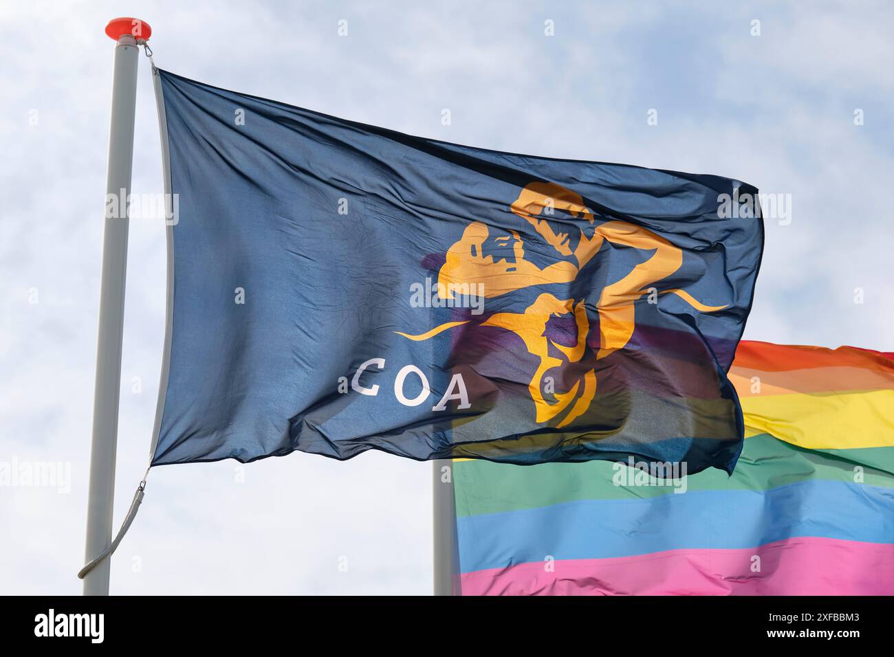 Flag of the COA and a rainbow flag at the entrance of a temporary housing location for asylum seekers or AZC in the Netherlands Stock Photo
