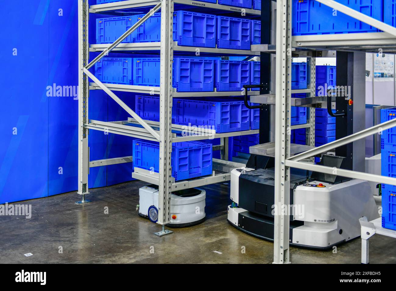 Autonomous Robot transportation in warehouses automation. Robots in storage hangar. AGV for moving racks, Warehouse automation concept. Stock Photo