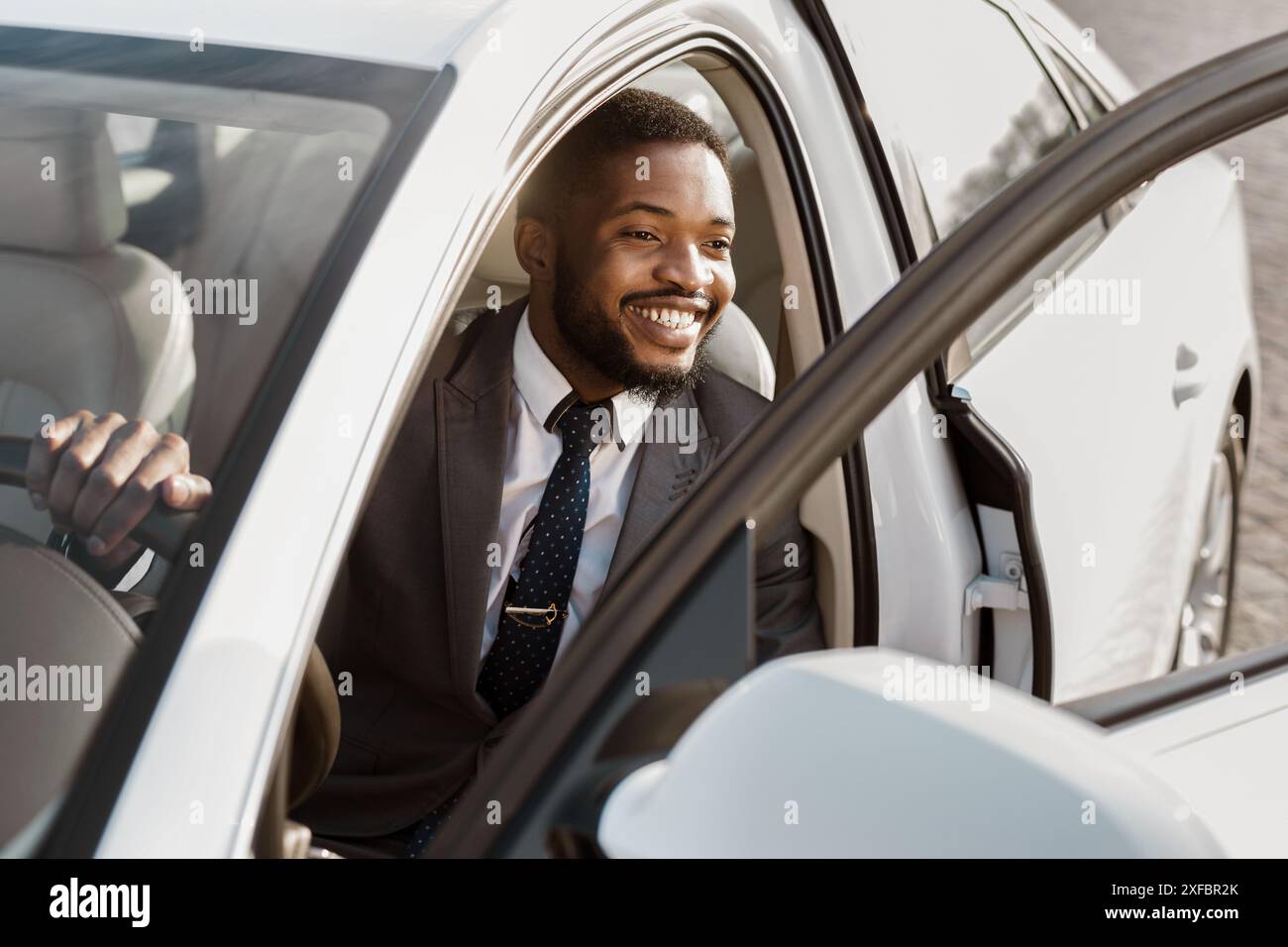 Stylish businessman in suit on sunny city street hi-res stock ...