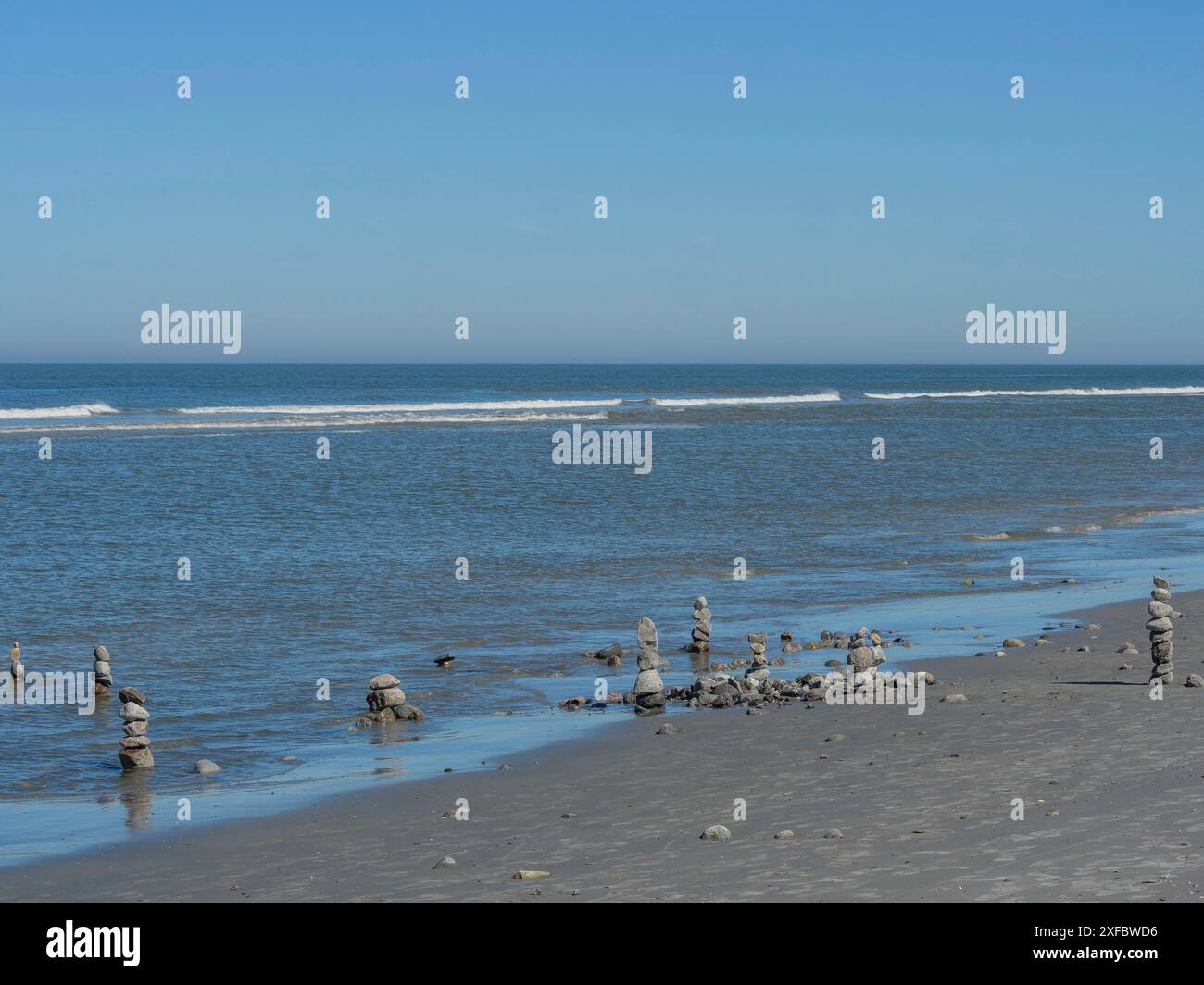 Stone towers balancing on a sandy beach overlooking the sea Stock Photo ...