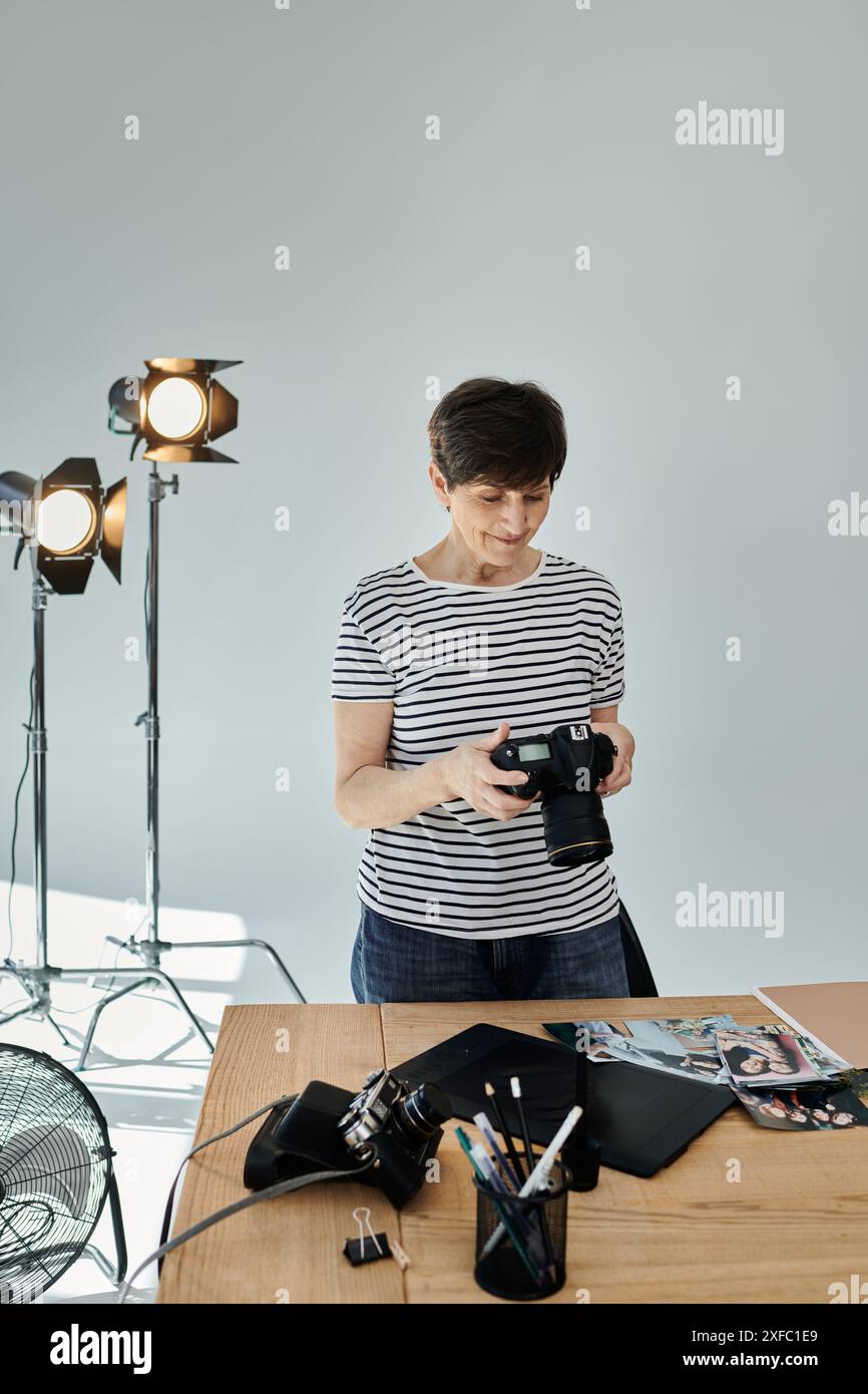 A woman adjusting settings on a camera for a professional photoshoot ...