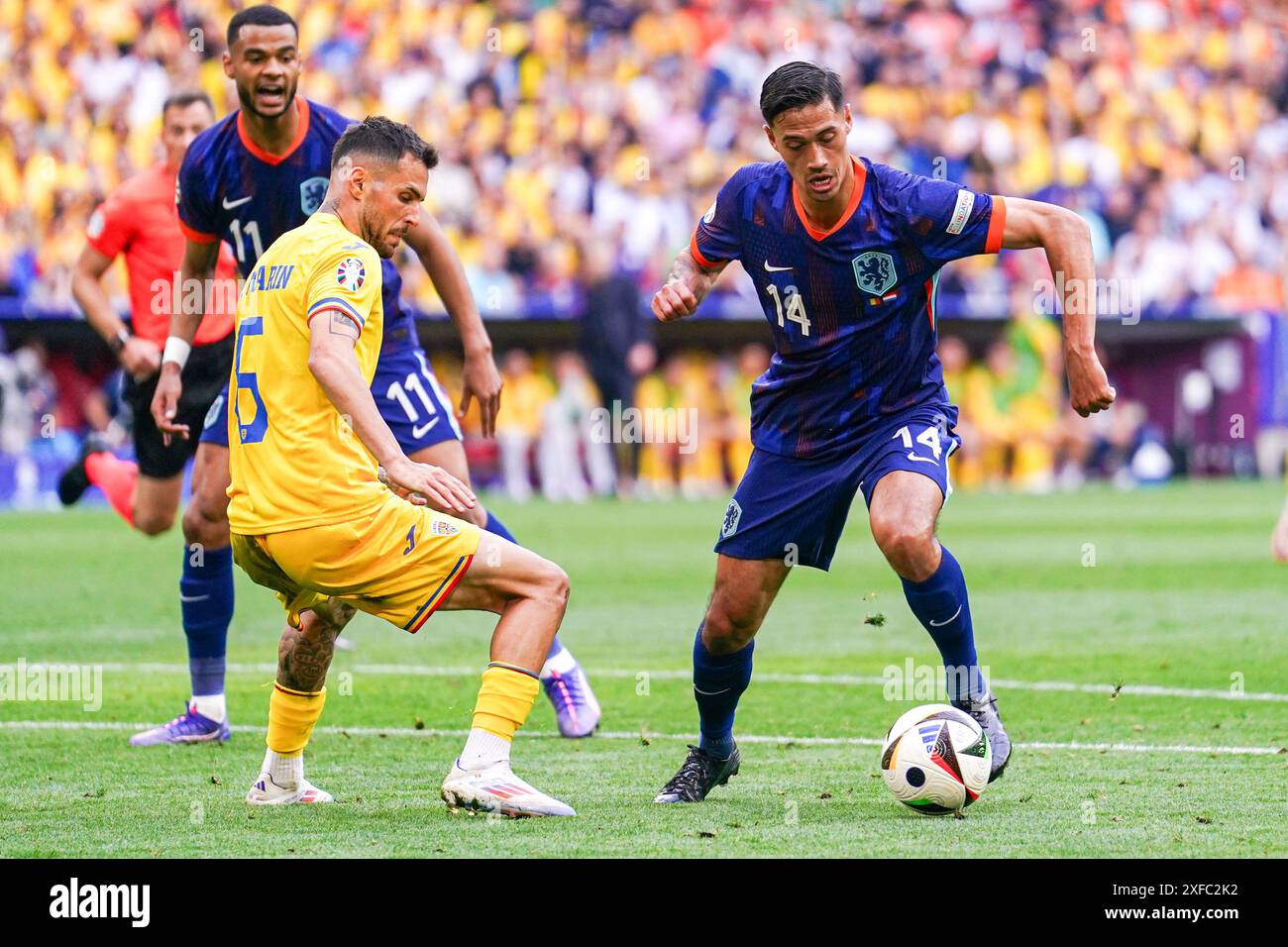 Munich, Germany. 02nd July, 2024. MUNICH, GERMANY - JULY 2: Marius Marin of Romania battles for possession with Tijjani Reijnders of the Netherlands during the Round of 16 - UEFA EURO 2024 match between Romania and Netherlands at Munich Football Arena on July 2, 2024 in Munich, Germany. (Photo by Joris Verwijst/BSR Agency) Credit: BSR Agency/Alamy Live News Stock Photo