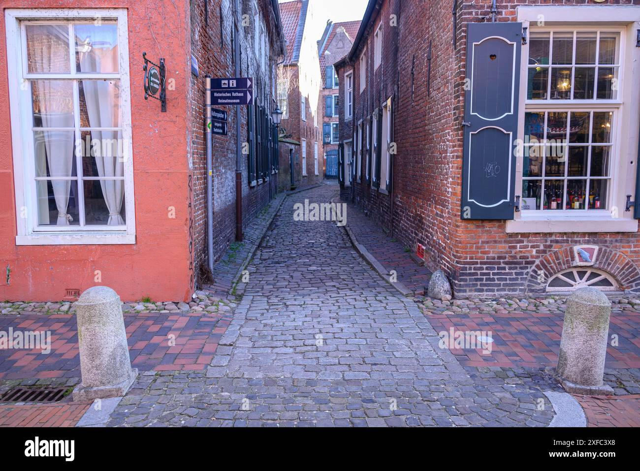 Small cobbled street between charming old buildings with shutters, historic city centre, empty, east frisia, germany Stock Photo