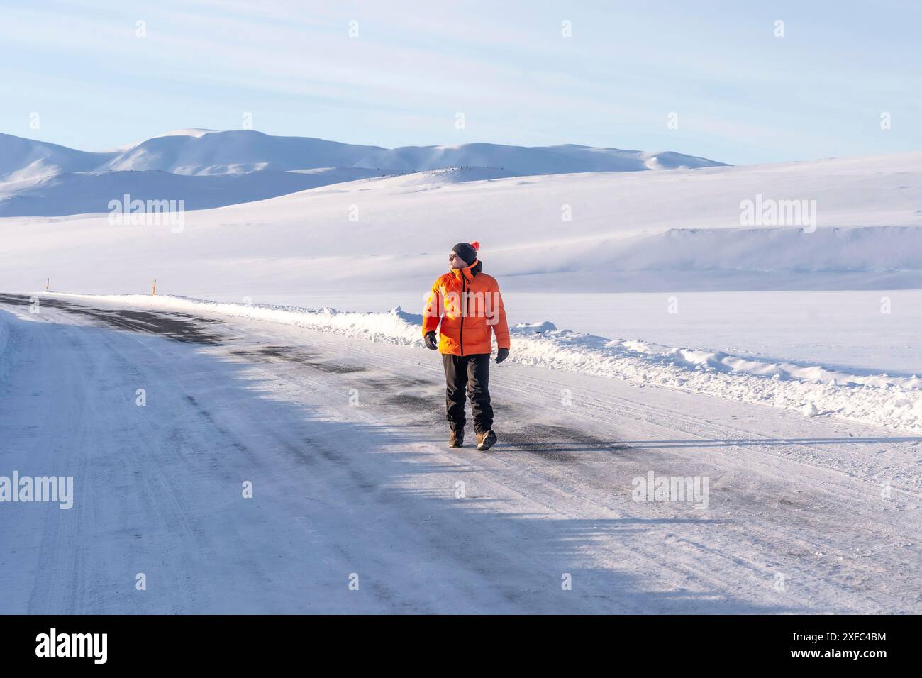 Man in orange jacket walks hi-res stock photography and images - Alamy