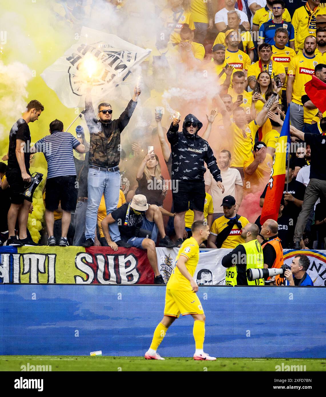 MUNICH - Romanian supporters light torches during the UEFA EURO 2024 round of 16 match between Romania and the Netherlands at the Munich Football Arena on July 2, 2024 in Munich, Germany. ANP KOEN VAN WEEL Stock Photo