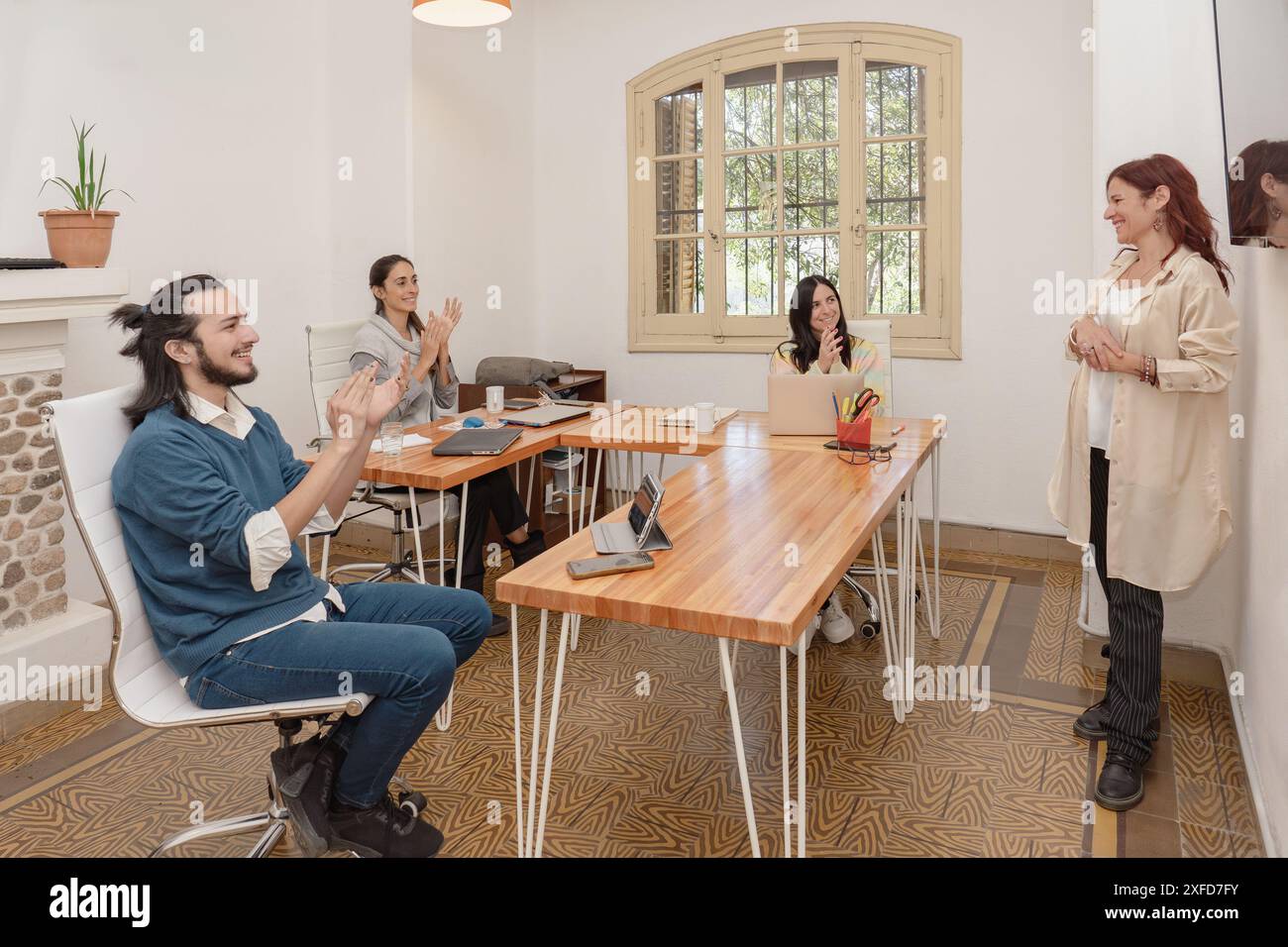 A group of diverse professionals applauding a successful presentation ...