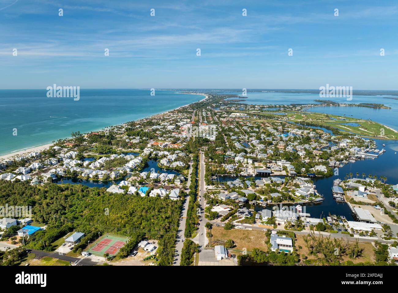 Expensive mansions between green palm trees on Gulf of Mexico shore in island small town Boca Grande on Gasparilla Island in southwest Florida, USA Stock Photo