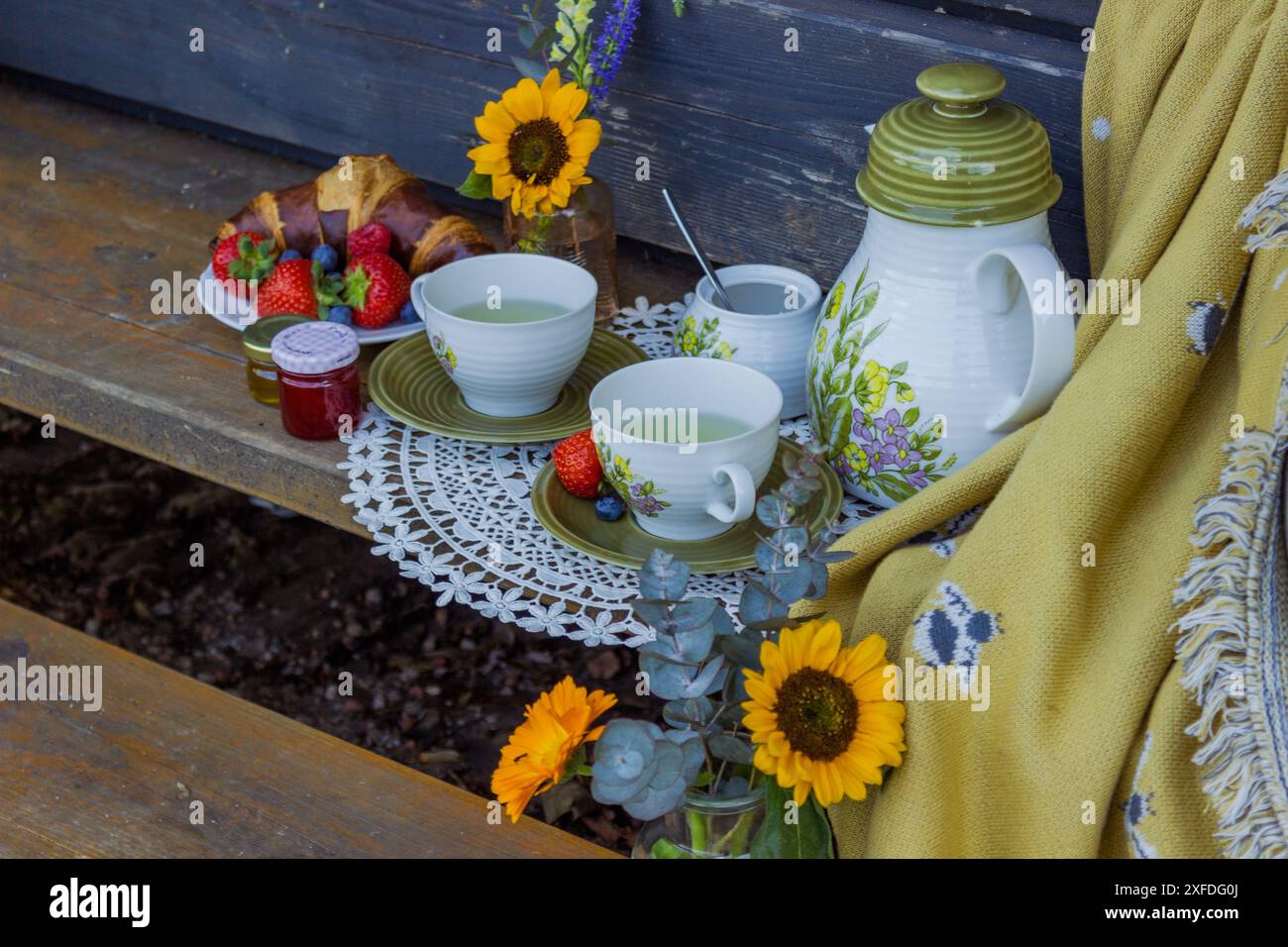 Morning summer tea with flowers and fruits on the veranda in the ...