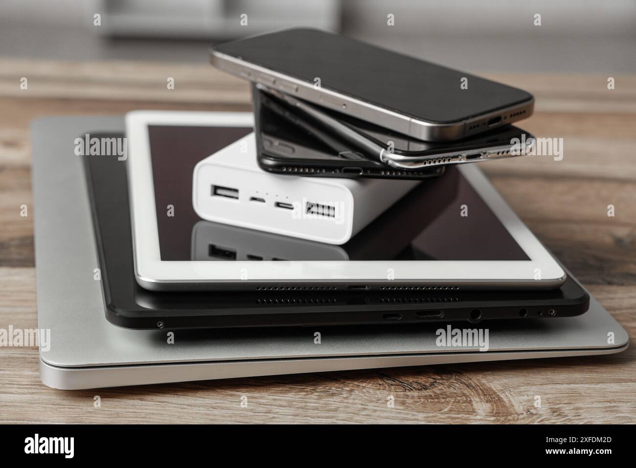 Stack of modern gadgets on wooden table Stock Photo