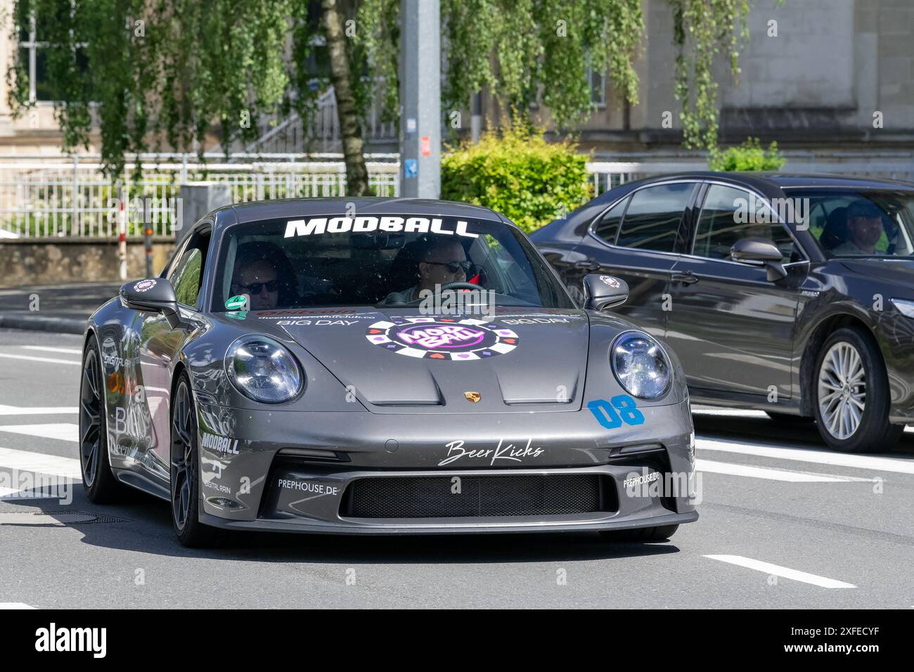 Luxembourg City, Luxembourg - View on a grey Porsche 992 GT3 Touring driving on a road. Stock Photo