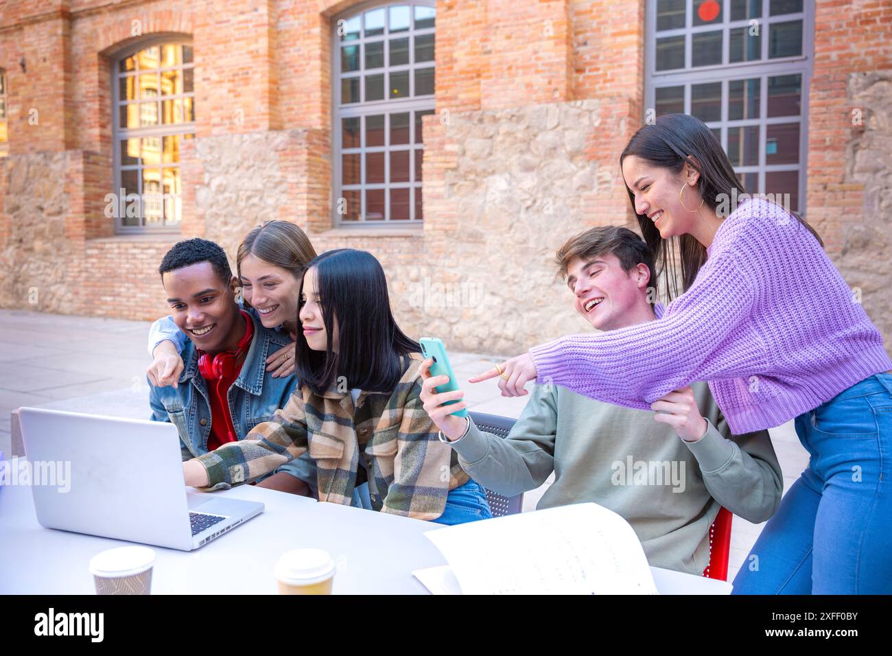 Group of students, prepare for university exams, use a laptop. Stock Photo