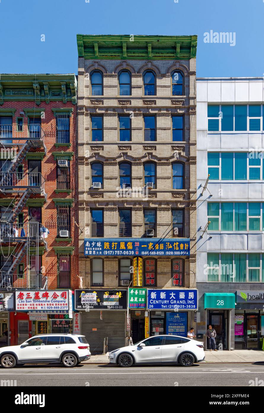 NYC Chinatown: 26 East Broadway is a six-story beige roman brick and terra cotta walk-up apartment building over street-level stores. Stock Photo