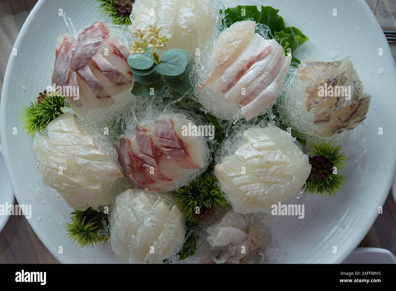 A table of fresh raw fish is served Stock Photo