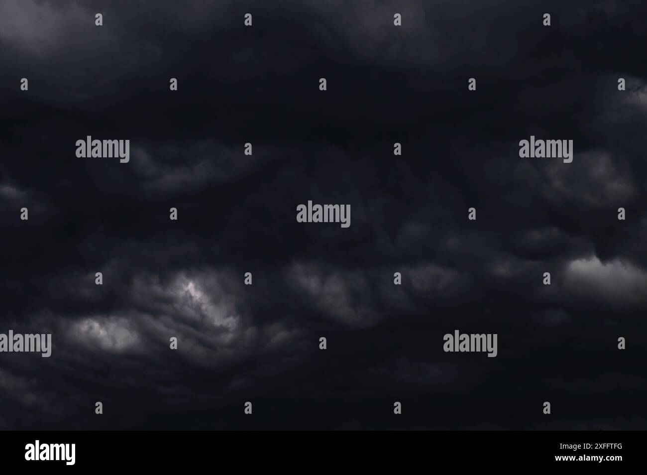 Dark storm clouds gathering in the sky creating a dramatic and moody ...