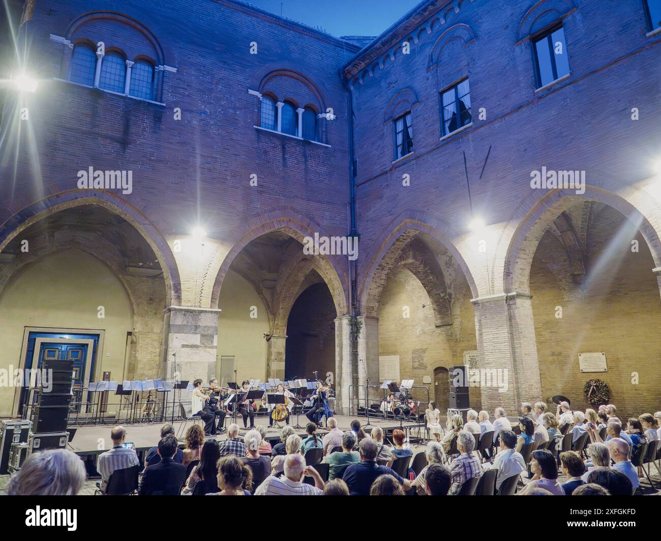 Cremona, Italy - June 28th 2024 Cremona Summer Festival Ensemble Miyaji, Audience delighting in a twilight classical music concert in the courtyard Stock Photo