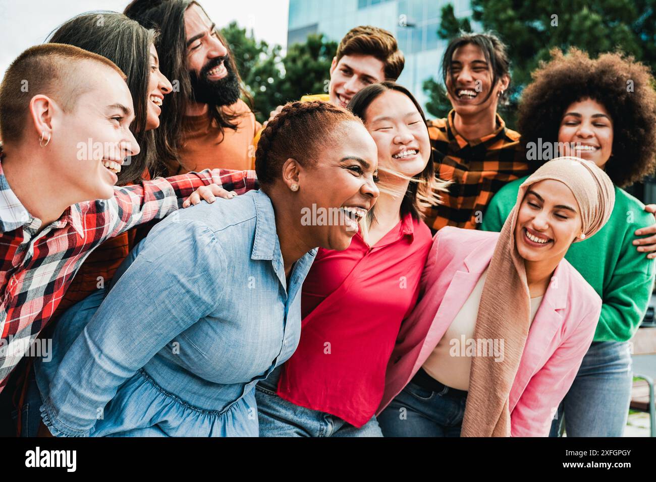 Diverse group of friends having fun in city in summer day. Young people celebrate holiday vacations outside Stock Photo