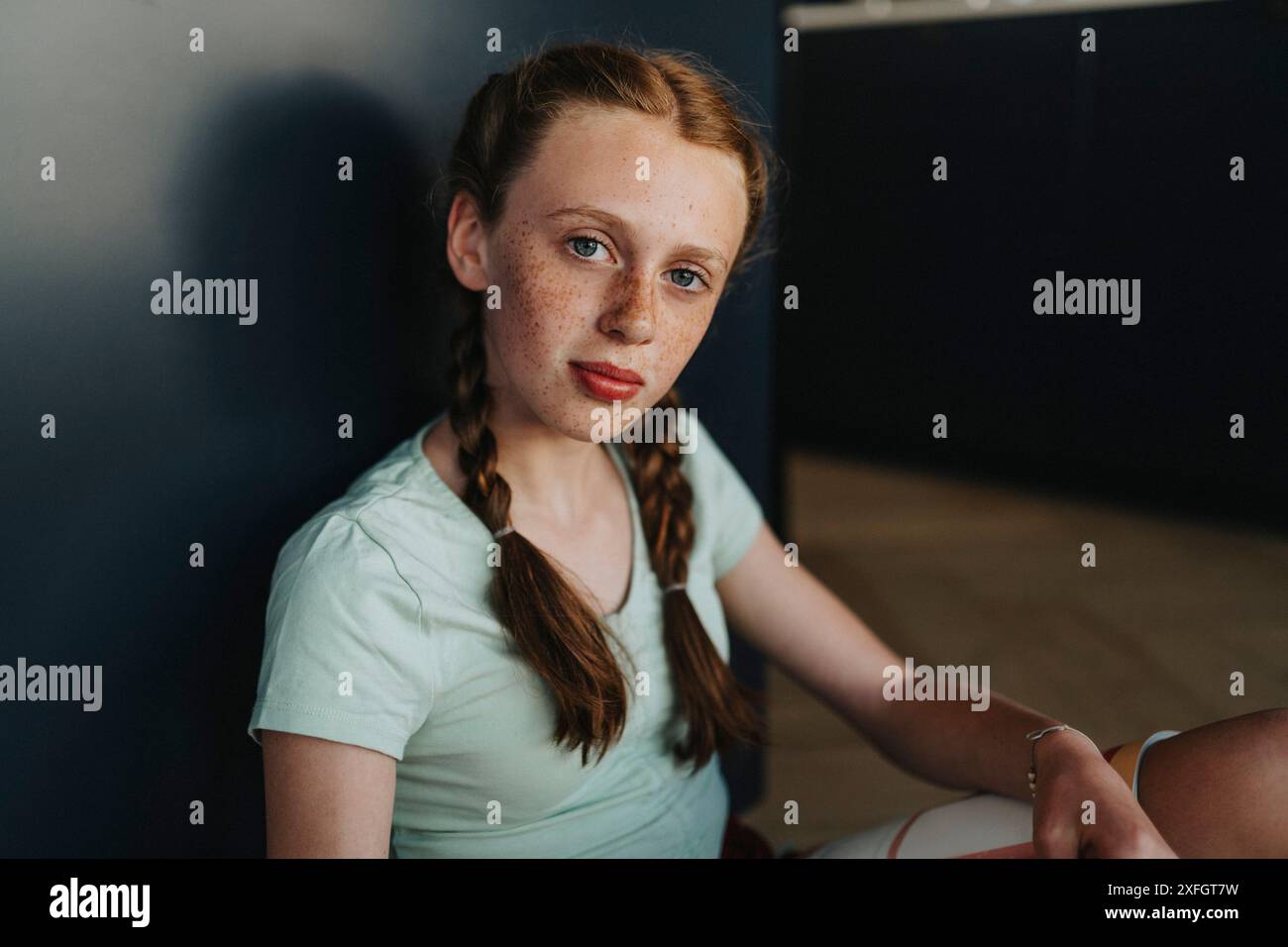 Portrait of girl with freckle and braids at home Stock Photo
