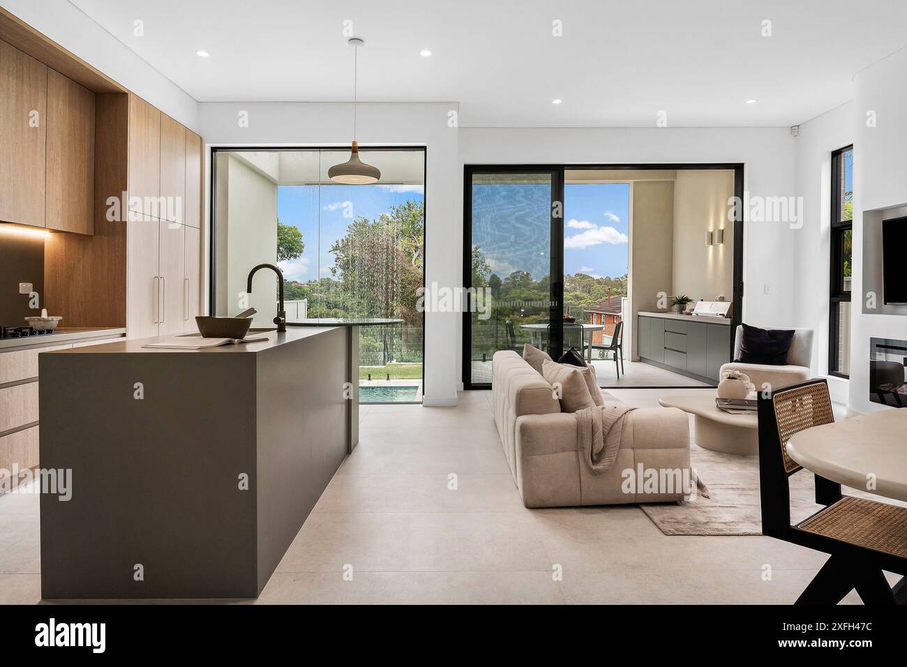 A Modern open-plan kitchen and living room with large windows and a ...
