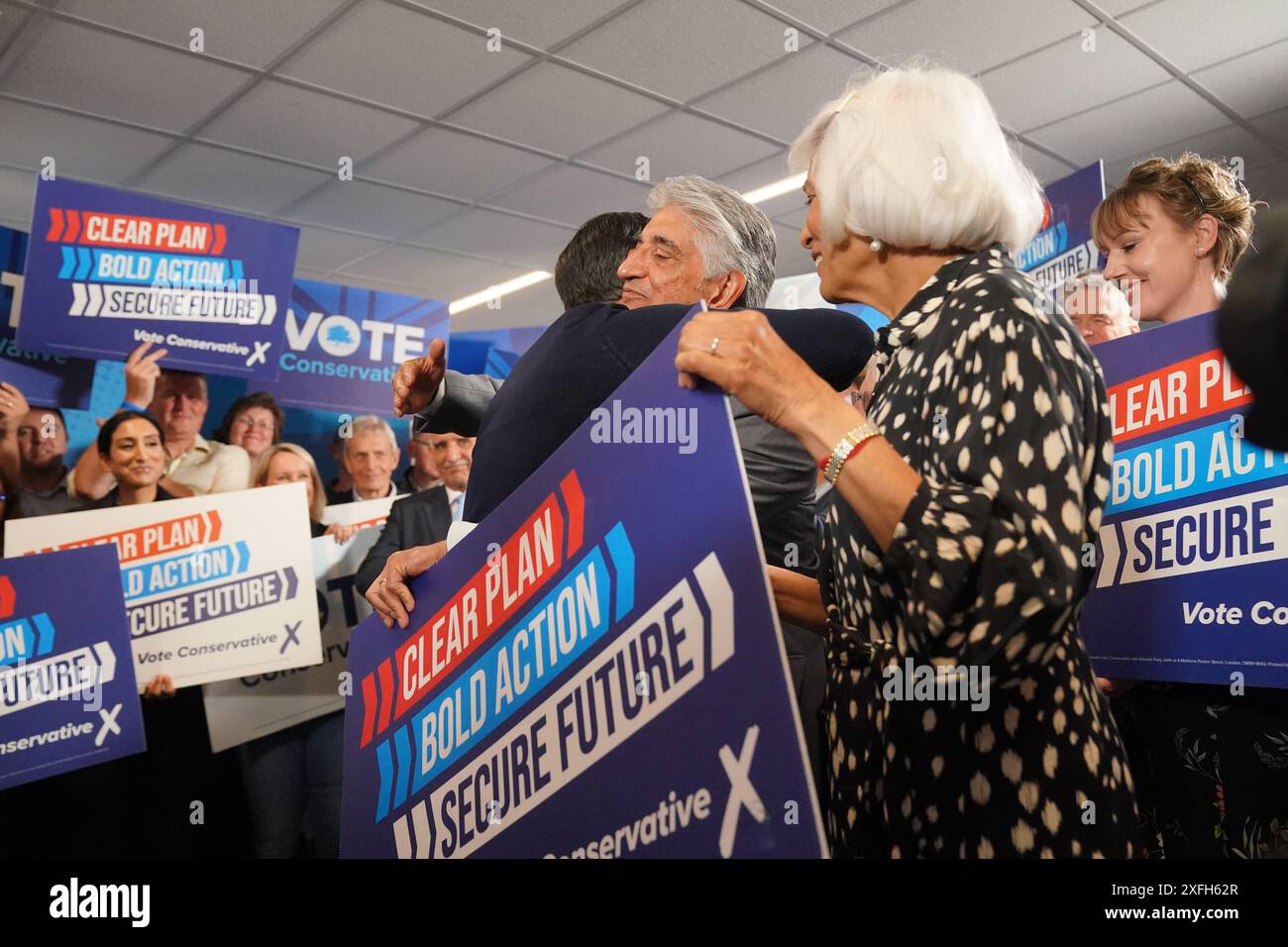 Prime Minister Rishi Sunak hugs his father Yashvir Sunak, as his mother ...