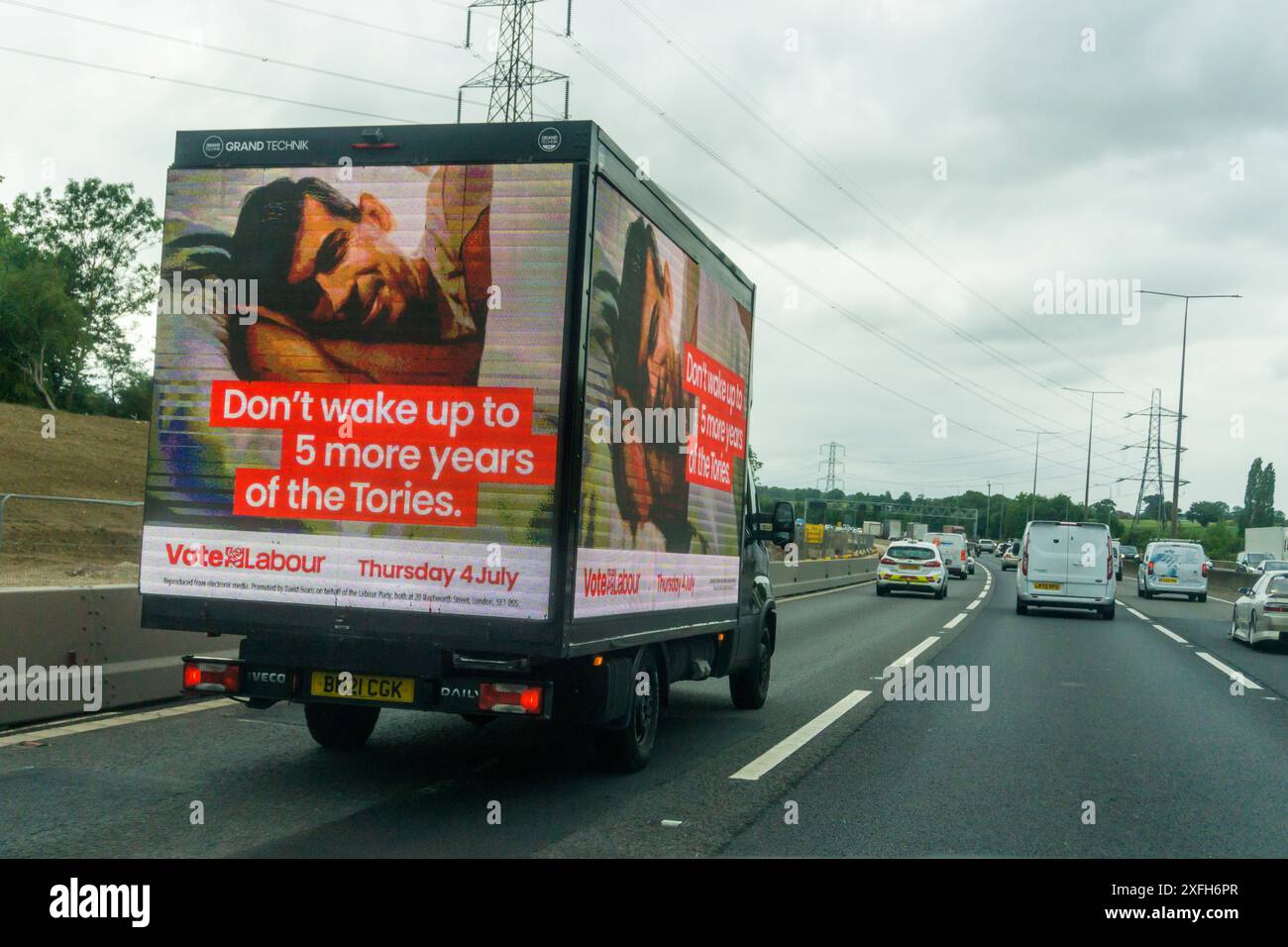 3 July 2024. On the last day before voting in the UK General Election a Labour Party advertising van is seen travelling on the M25 in Essex with the message Don't wake up to 5 more years of the Tories and an image of Rishi Sunak in bed. Stock Photo