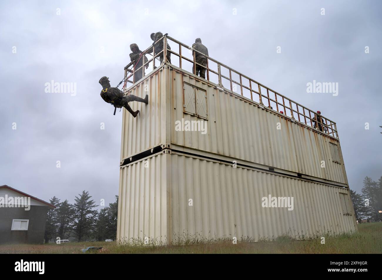 Airmen and Soldiers from the Oregon National Guard rappel off a storage ...