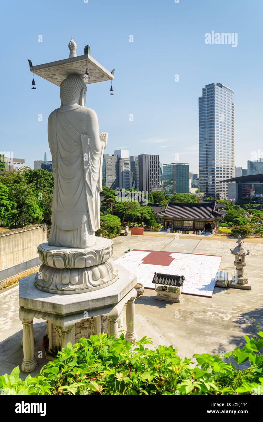 Beautiful view of Seoul skyline from Bongeunsa Temple at Gangnam District in Seoul, South Korea. Back view of Buddha statue. Stock Photo