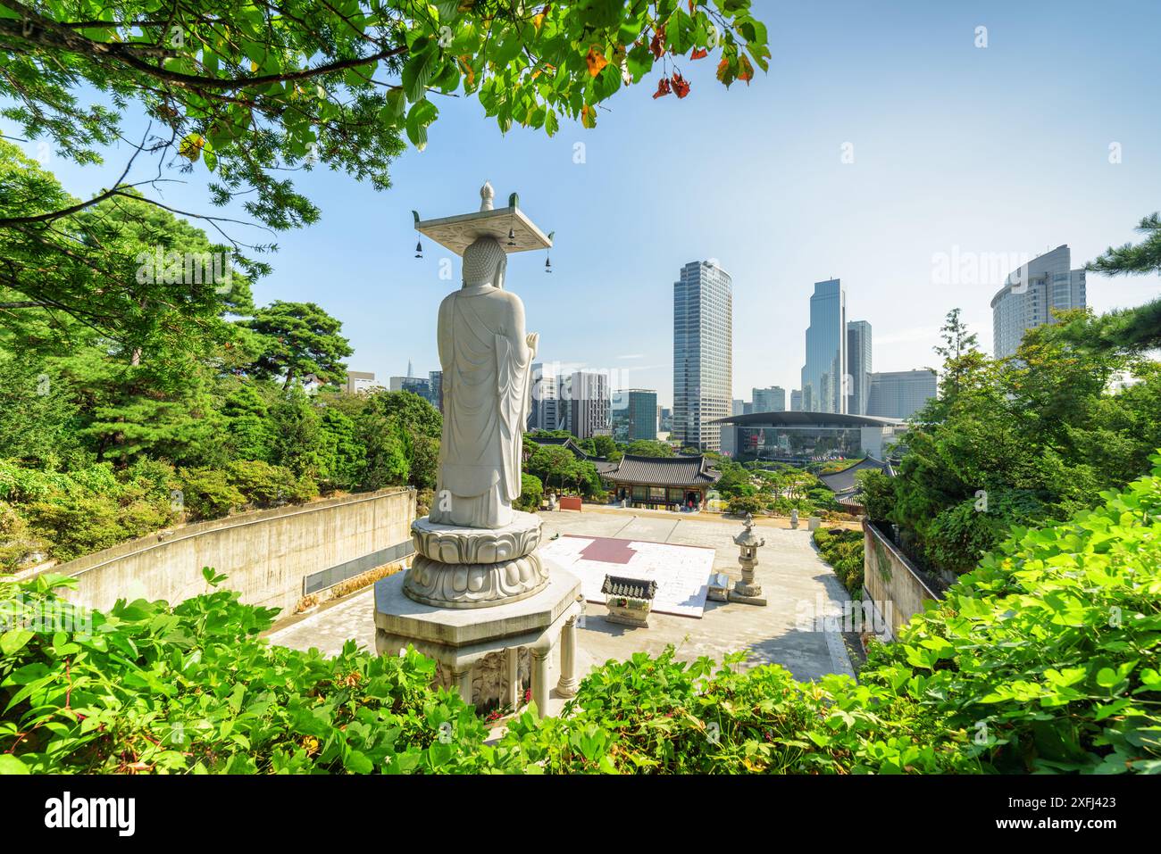 Beautiful view of Seoul skyline from Bongeunsa Temple at Gangnam District in Seoul, South Korea. Back view of Buddha statue. Stock Photo