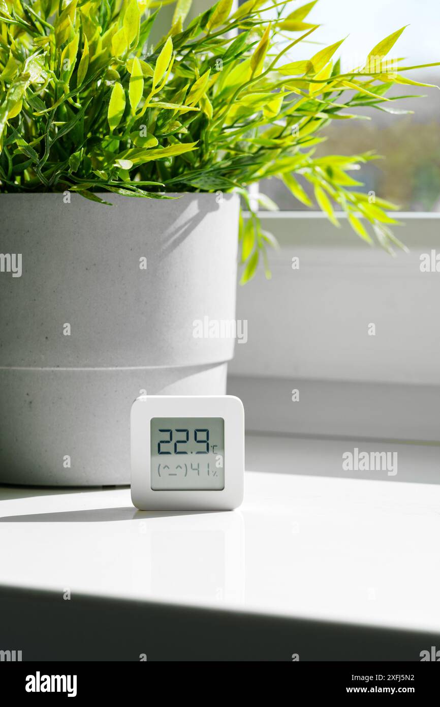 White Digital Thermometer Displaying Room Temperature and Humidity ...