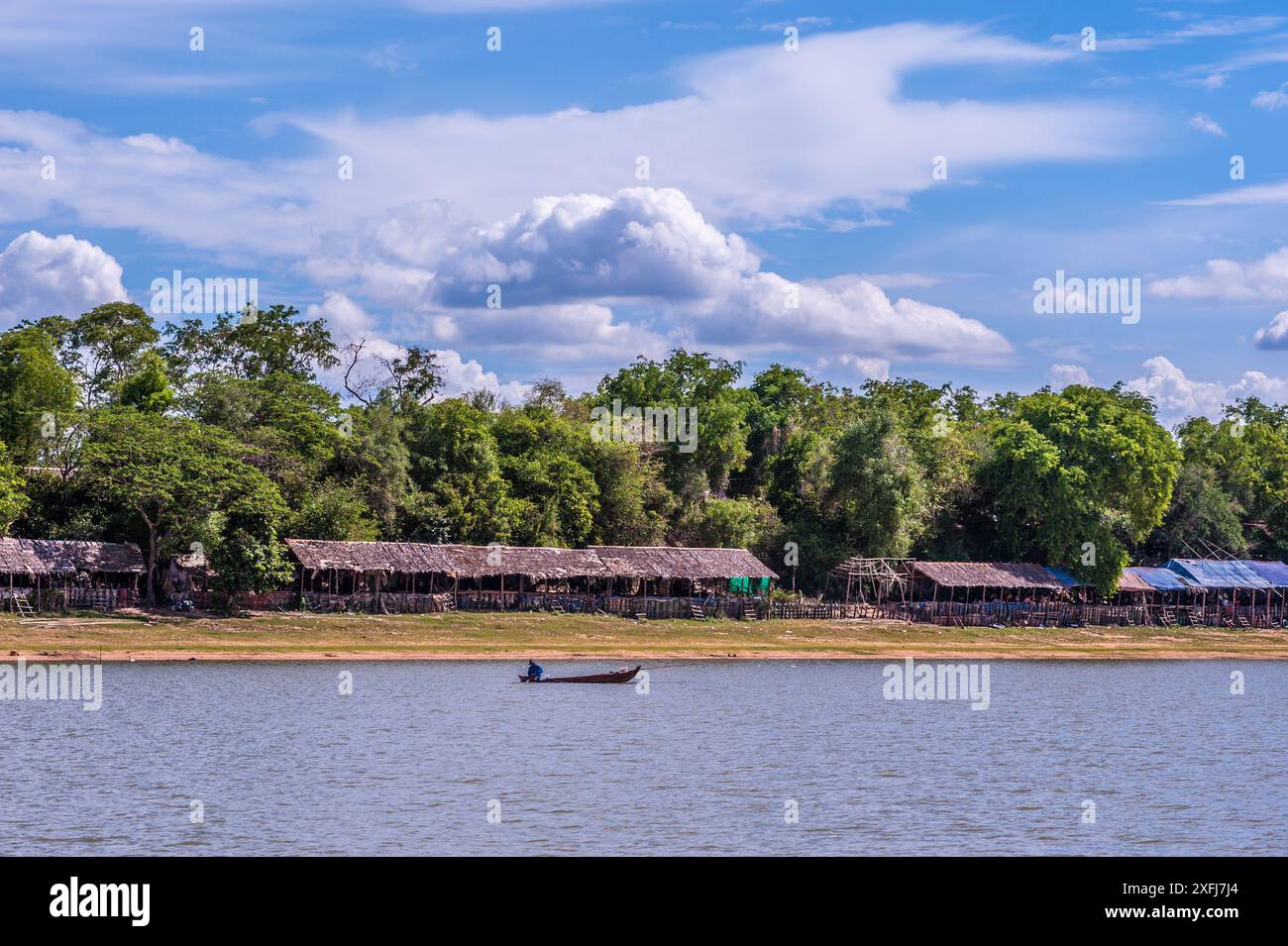 Thatched roof huts & a fisherman on the West Baray Reservoir. Angkor ...