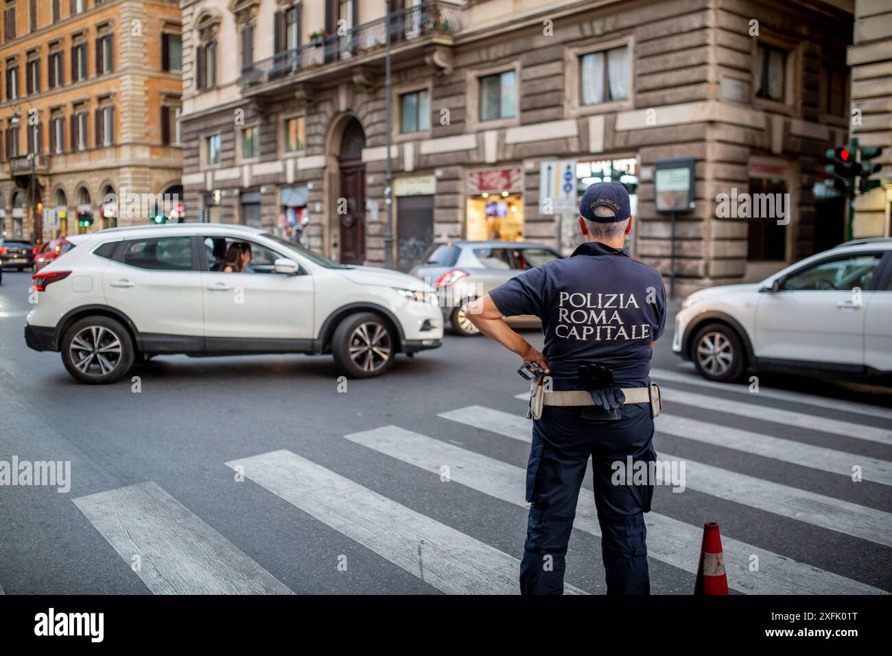 Rome, Italy - June 29, 2024: Police officer directing the traffic on the streets of Rome, Italy. Stock Photo