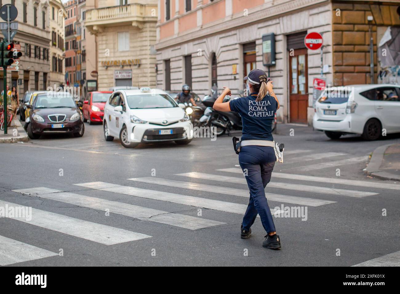 Rome, Italy - June 29, 2024: Police officer directing the traffic on the streets of Rome, Italy. Stock Photo