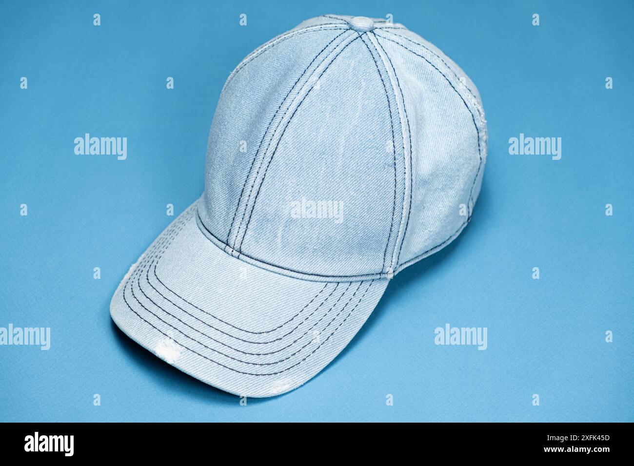 Blue denim cap close-up on blue background Stock Photo