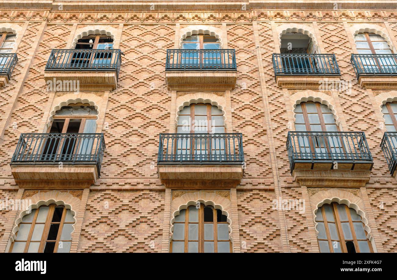 Detailed view of a brick building facade featuring arched windows and ...
