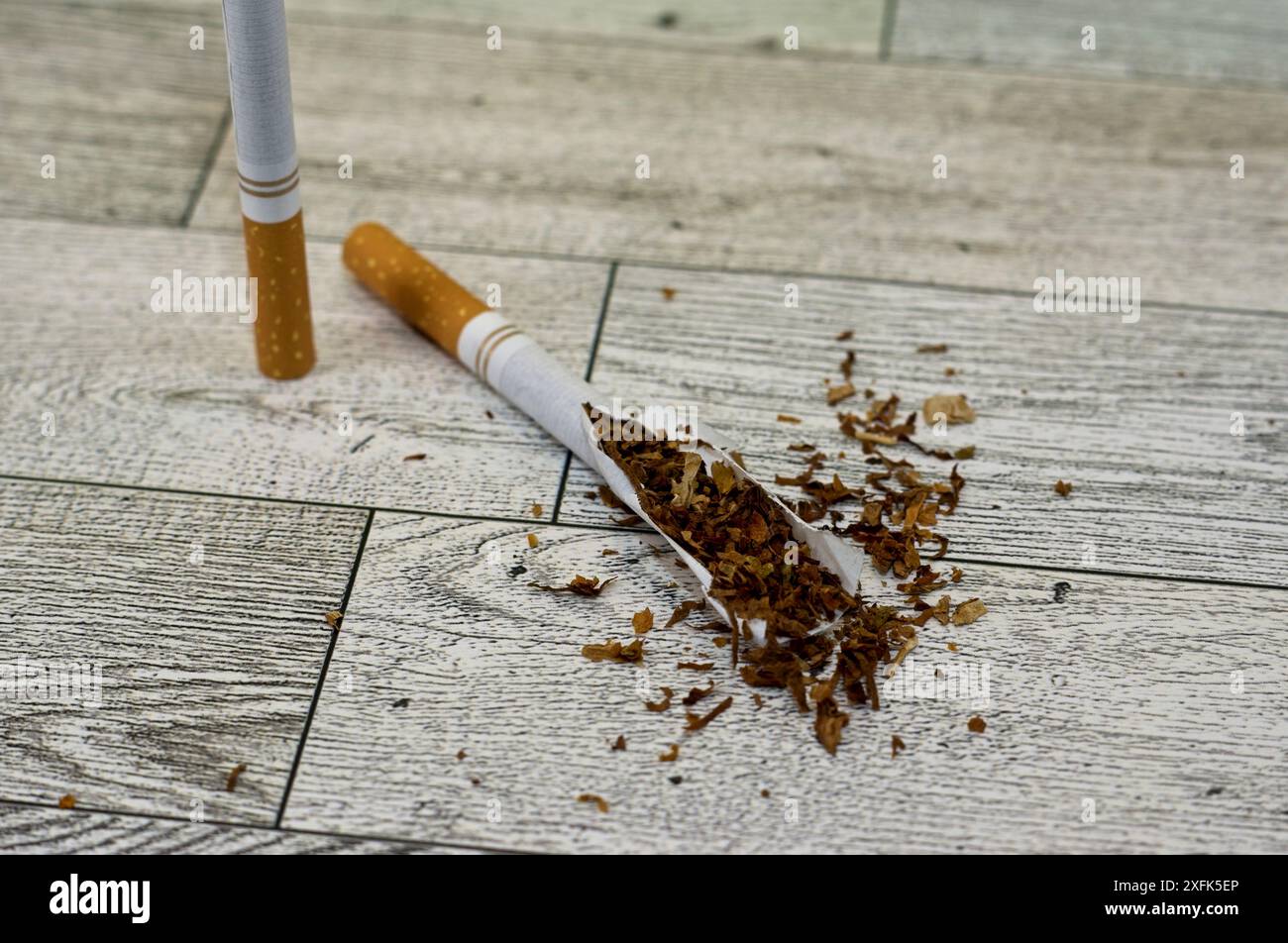 Cigarette split with tobacco showing as if in surgery Stock Photo