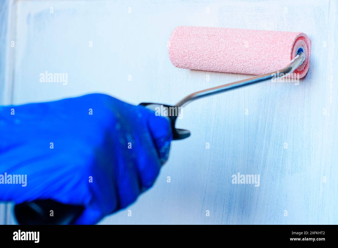 Painting an old piece of furniture white to renovate Stock Photo Alamy