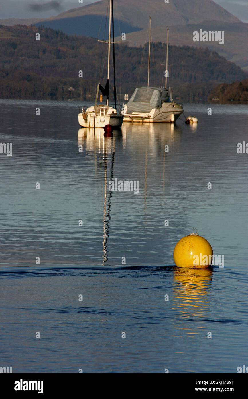 Calm serene shimmering lake boats hi-res stock photography and images ...