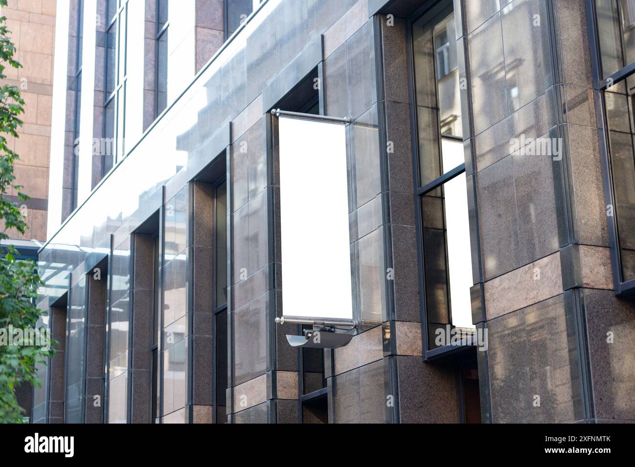 Roll-up billboard mockup on modern company building, isolated in white for banner promotion. Perfect for showcasing advertisements and marketing campa Stock Photo