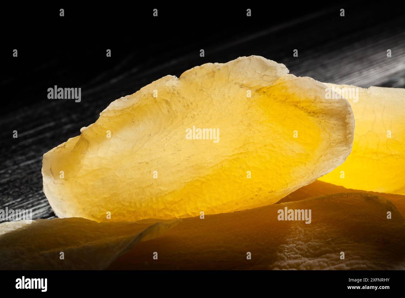 dried mango on black wood background top view Stock Photo