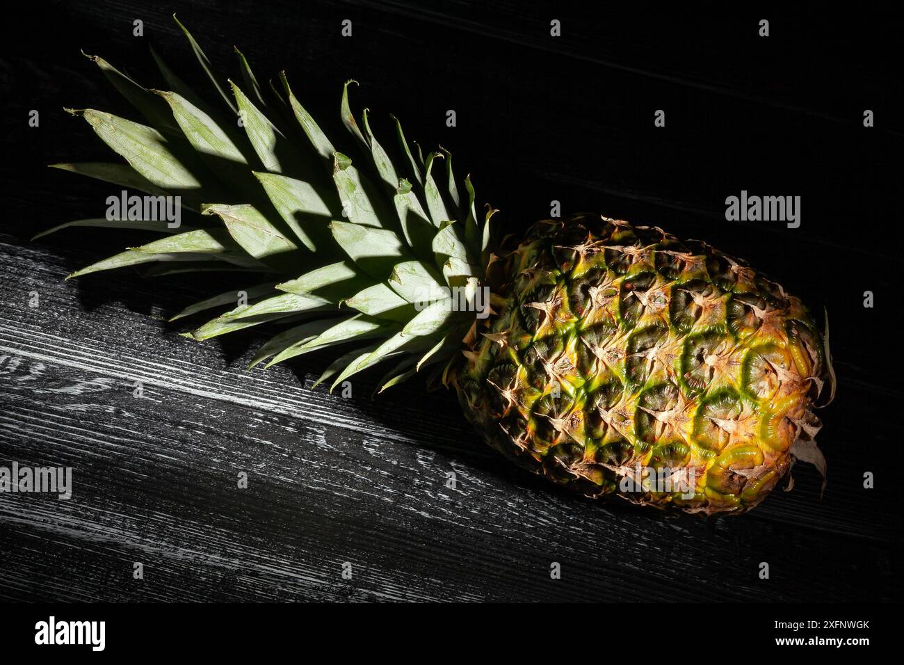 pineapple on black wood background Stock Photo