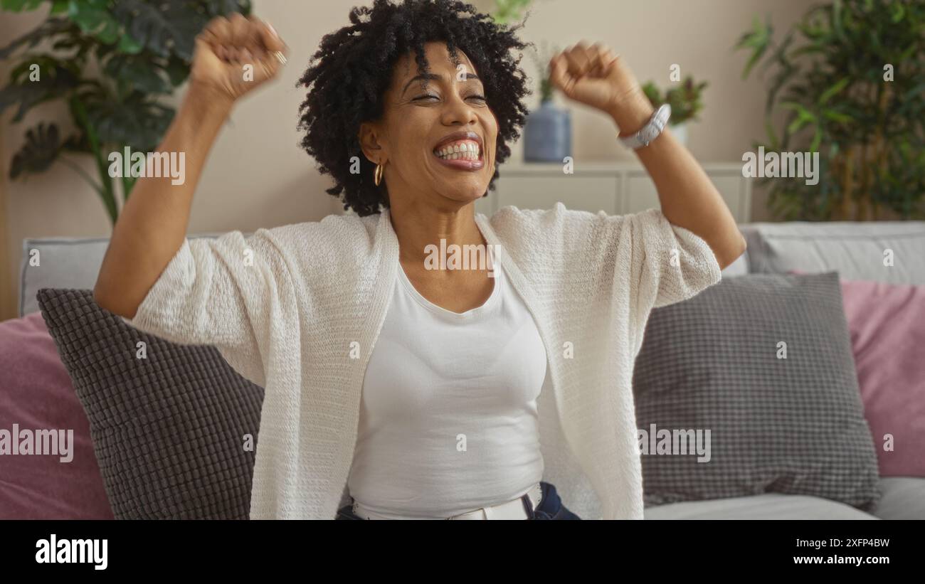 African american woman raising arms hi-res stock photography and images ...