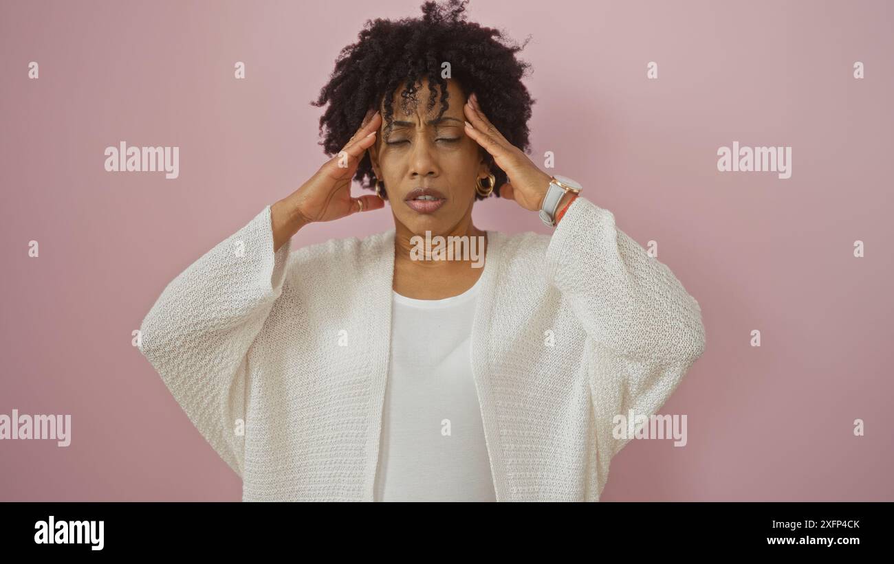 A beautiful young african american woman with curly hair is standing in ...