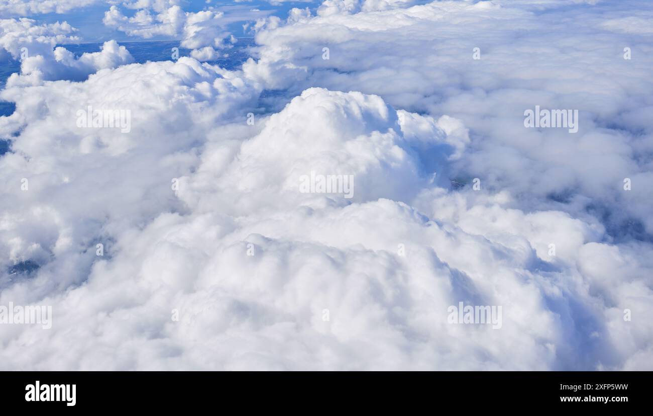 Aerial view of fluffy cumulus clouds from above, depicting a serene ...
