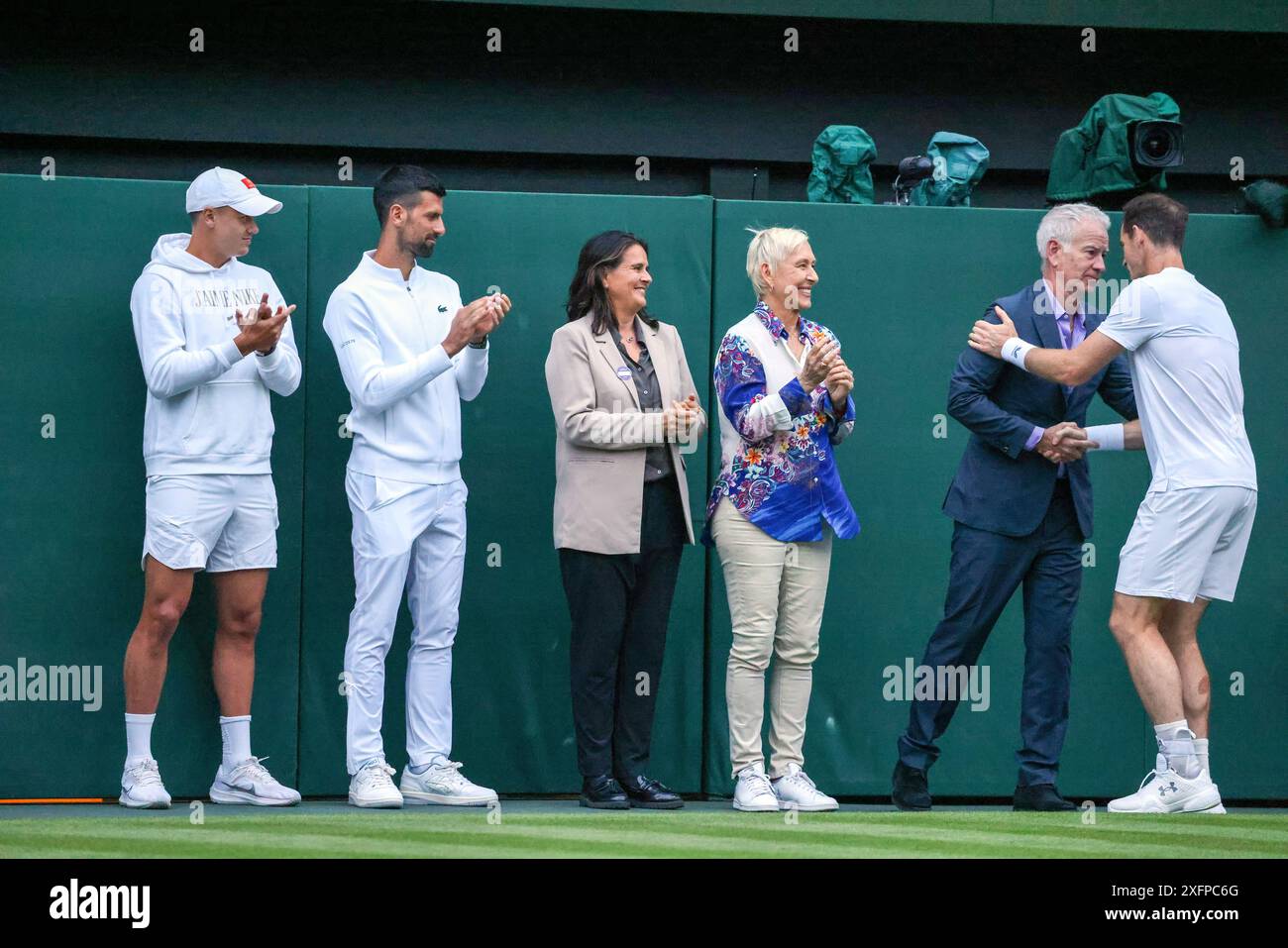 Wimbledon, London, UK. 04th July, 2024. Andy Murray receives congratulations from John McEnroe as Martina Navratilova, Conchita Martinez, Novak Djokovic and Holger Rune look on after an emotional tribute to Murray's career was presented on Centre Court following his doubles match today. Credit: Adam Stoltman/Alamy Live News Stock Photo