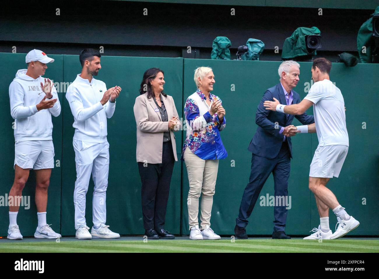 Wimbledon, London, UK. 04th July, 2024. Andy Murray receives congratulations from John McEnroe as Martina Navratilova, Conchita Martinez, Novak Djokovic and Holger Rune look on after an emotional tribute to Murray's career was presented on Centre Court following his doubles match today. Credit: Adam Stoltman/Alamy Live News Stock Photo