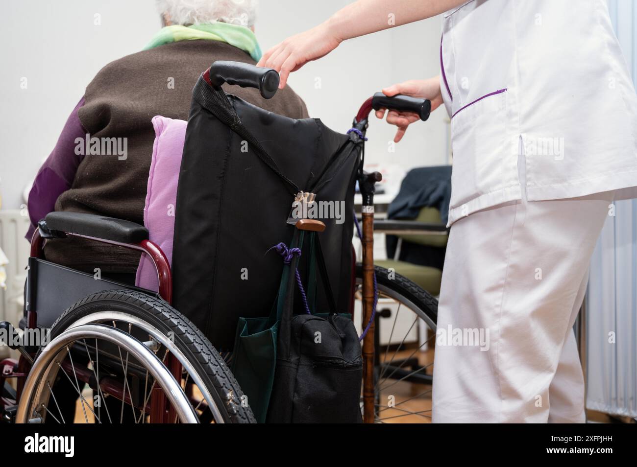 Young woman doctor give support to old lady patient with disability ...