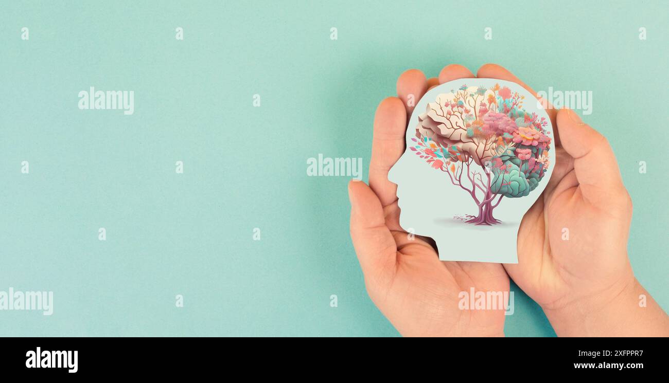 Hands holding head, human brain with flowers, self care and mental health concept, positive thinking, creative mind Stock Photo