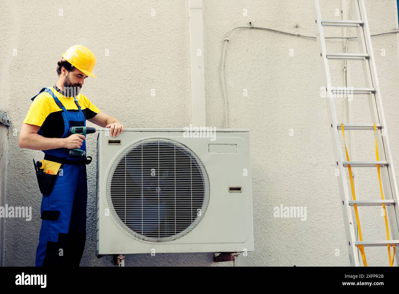 Qualified repairman starting work on faulty air conditioner, using